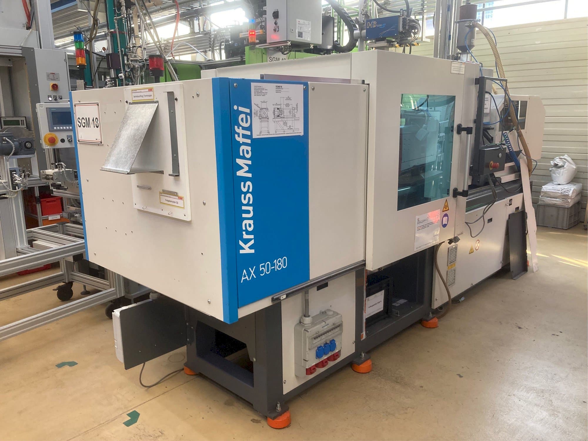 Mašīnas Krauss Maffei AX 50-180 kreisās malas skats