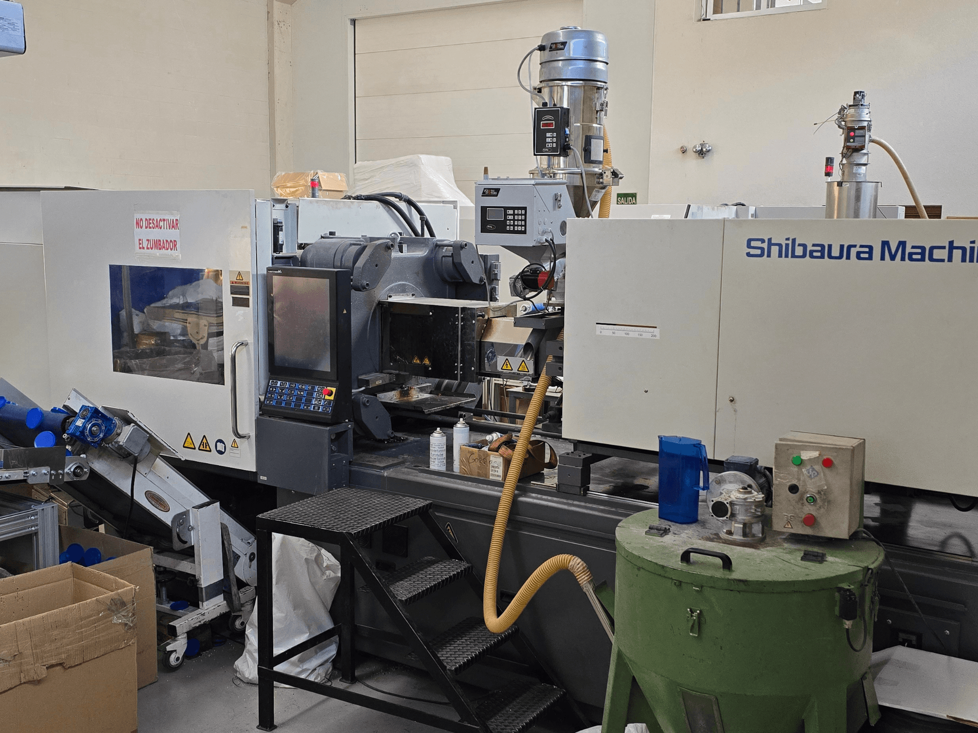 SHIBAURA EC230SXIII-8A elektriskās iesmidzināšanas iekārtas priekšējais skats ar vadības paneli un blakus esošajām iekārtām.