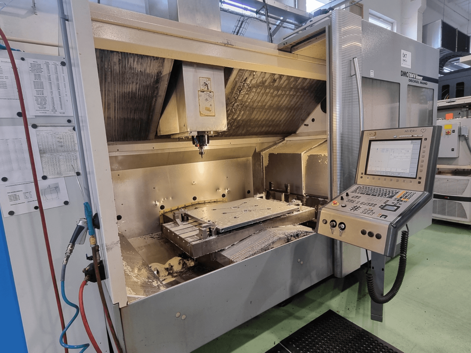 DMG DECKEL MAHO DMC 104V lineārais vertikālais apstrādes centrs, skats no priekšpuses, kurā redzama vadības pults un apstrādes zona.