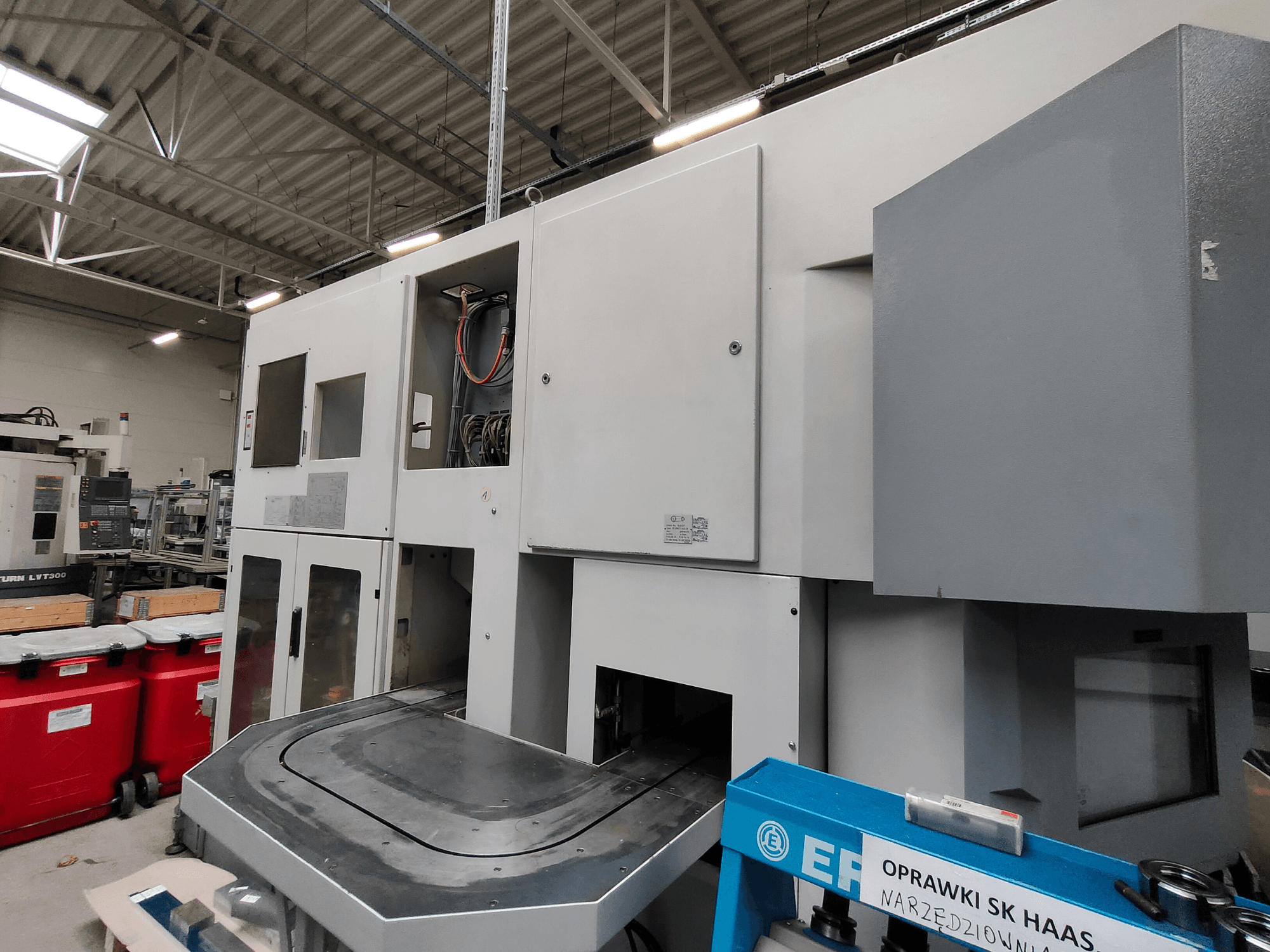 EMAG VSC 250 vertikālās virpošanas iekārta no sāniem ar vadības paneļiem un lielu darba laukumu.