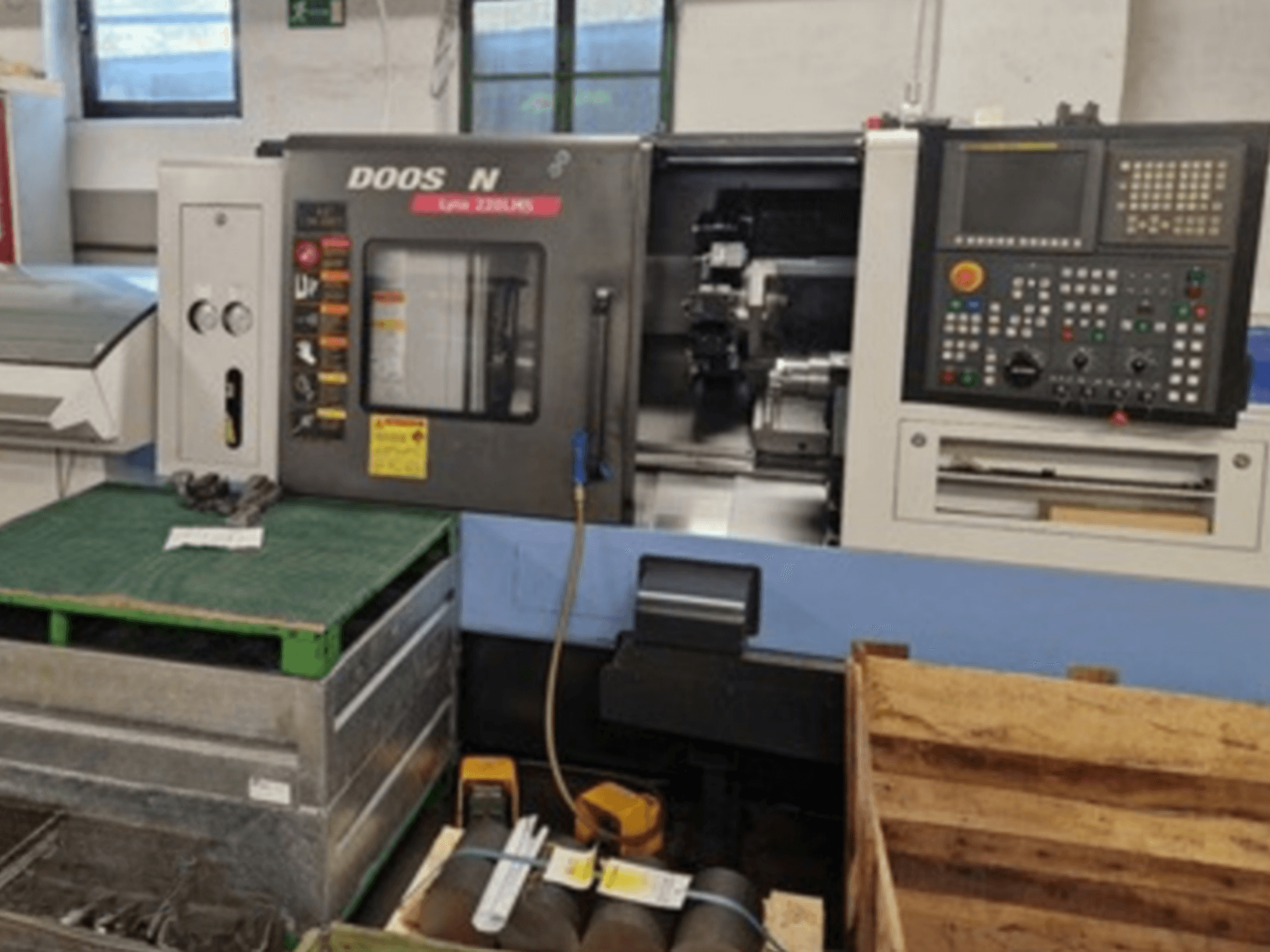 DOOSAN Lyax 220 LMS horizontālās virpošanas darbgalds priekšpusē, kurā redzams vadības panelis, instrumenti un darba vieta.