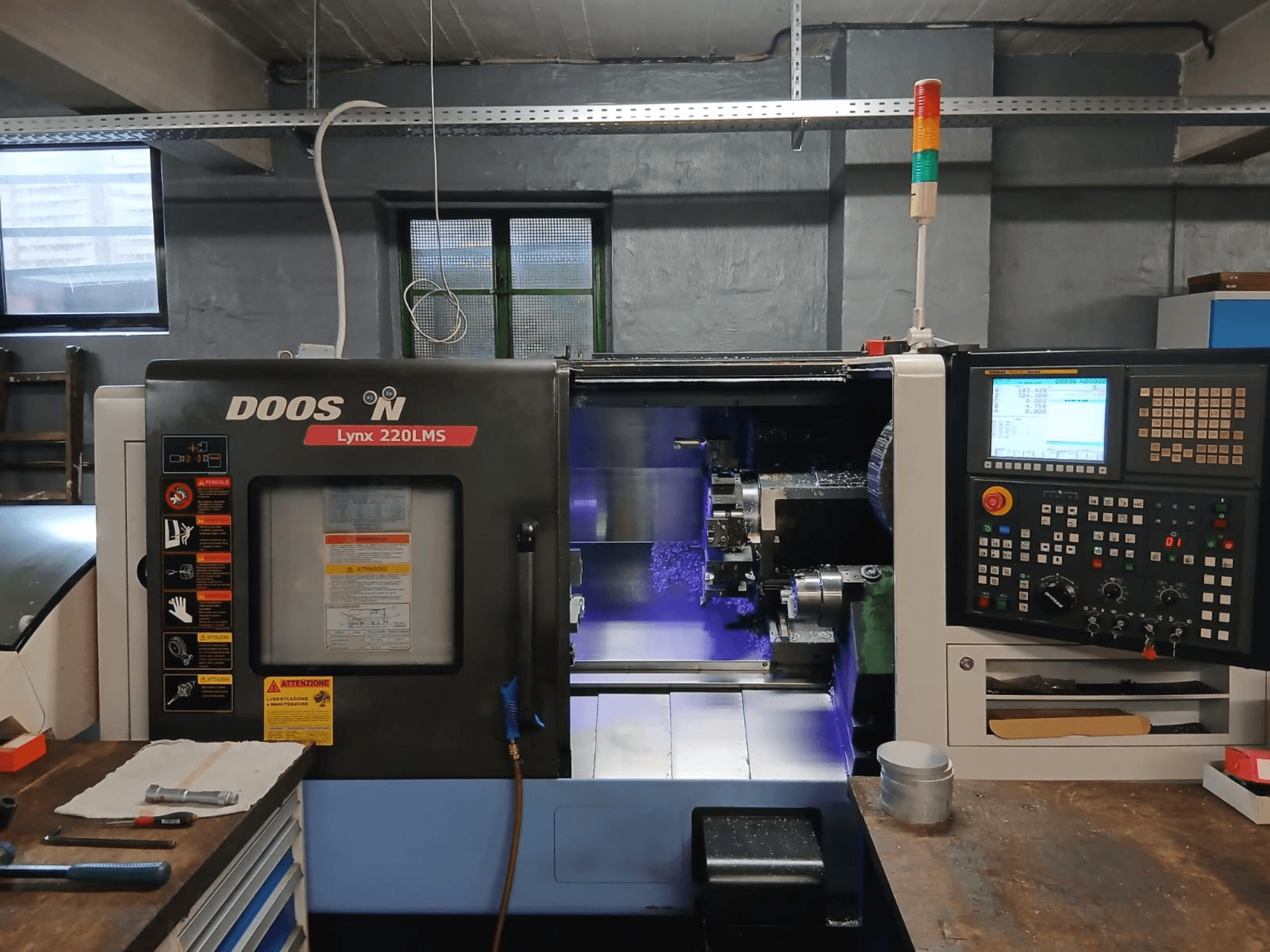 DOOSAN Lynx 220 LMS horizontālā virpošanas mašīna, skats no priekšpuses, kurā redzams vadības panelis un apstrādes zona.