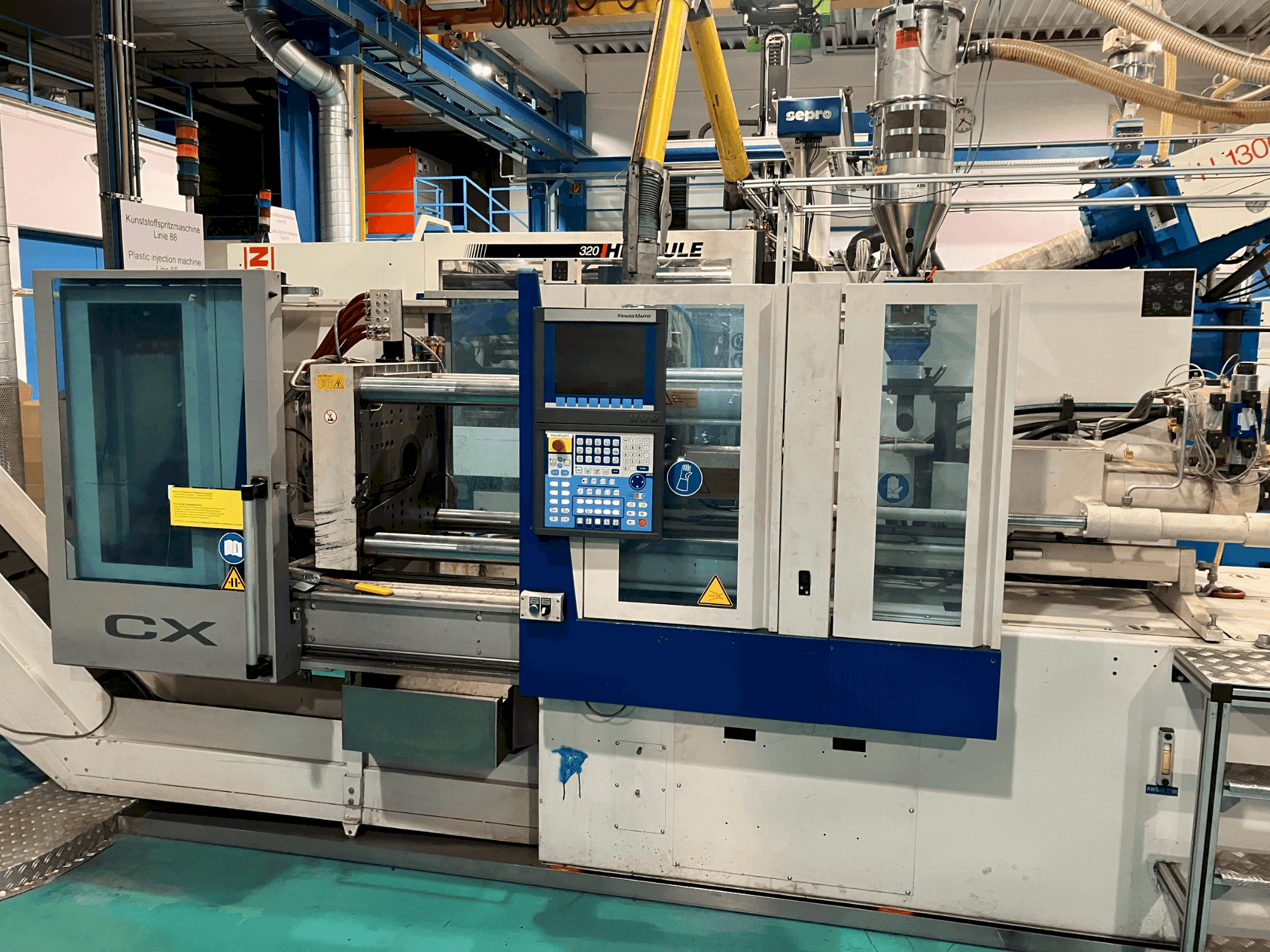 Mašīnas Krauss Maffei 65-180 CX pretskats