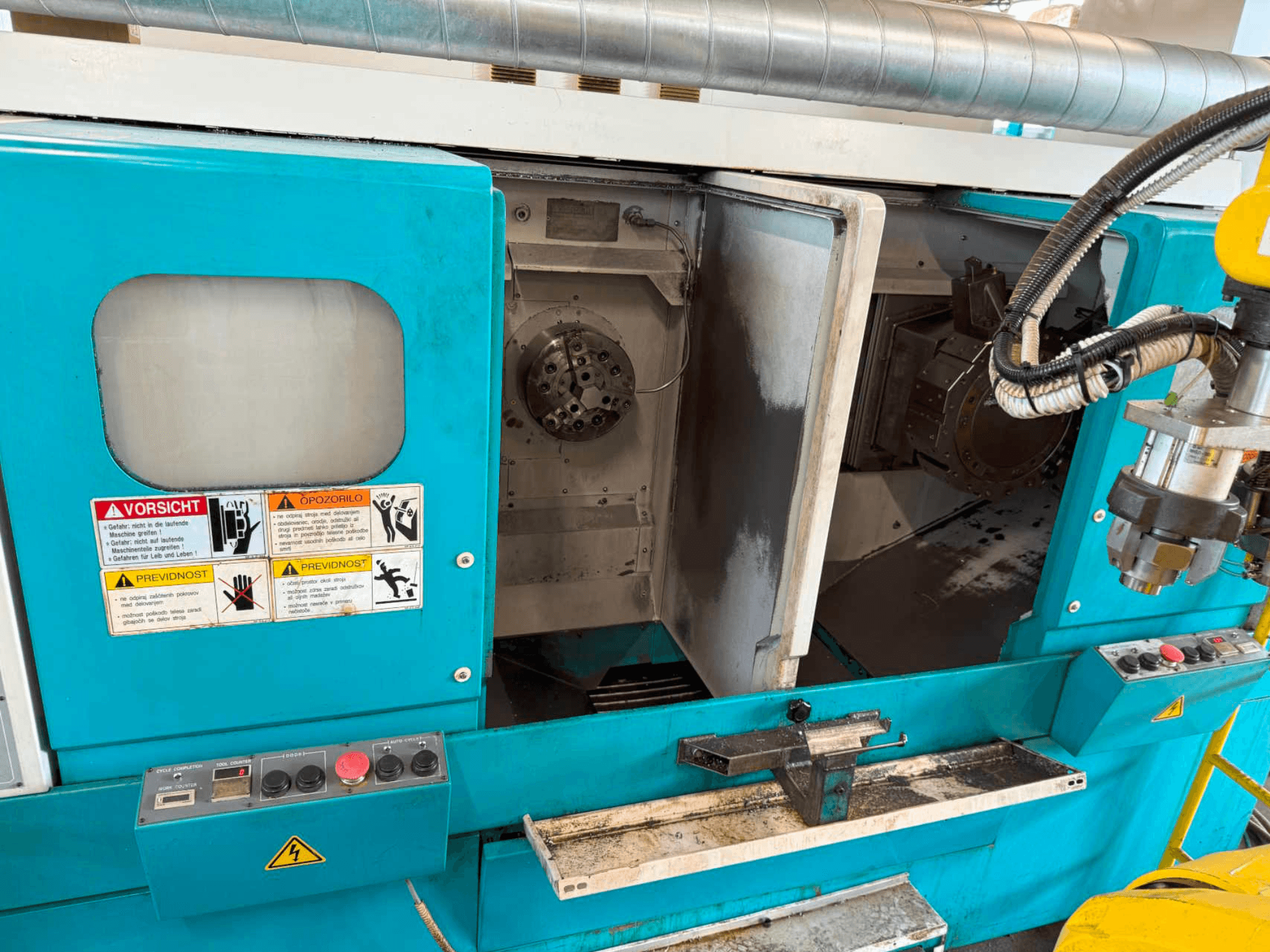 DOOSAN H310T horizontālās virpošanas iekārta, priekšējais skats, kurā redzams vadības panelis un vārpstas zona ar drošības brīdinājumiem.