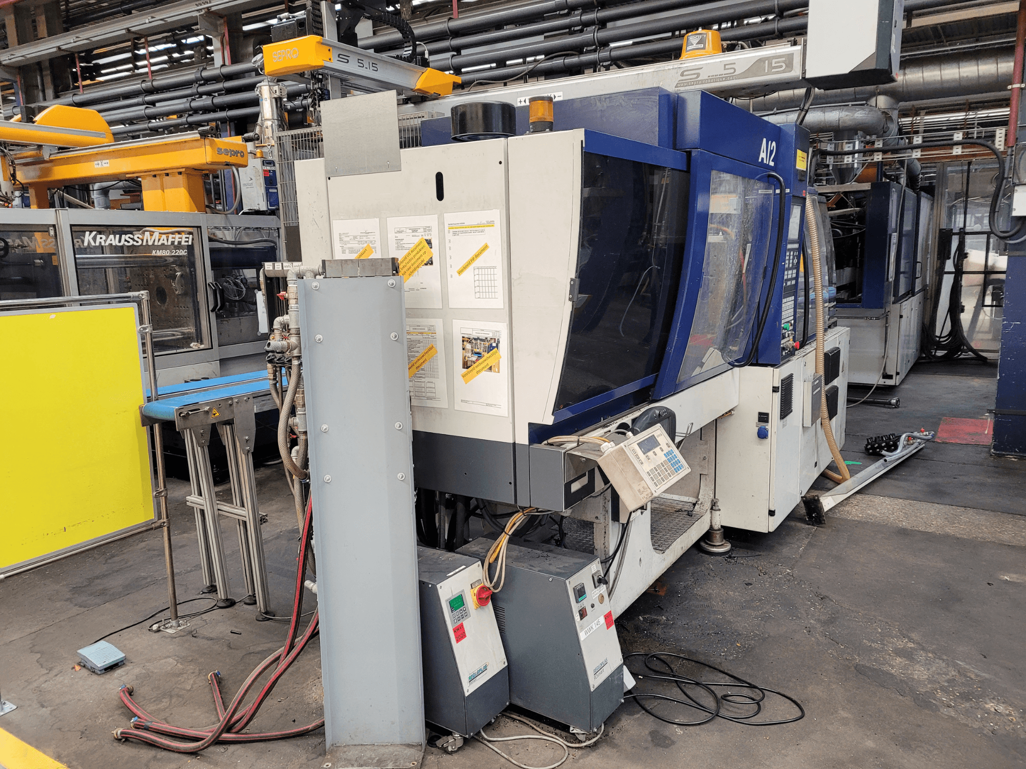 KraussMaffei liešanas mašīnas modelis KM80-232G, priekšējais skats, ar vadības paneli un darbības komponentiem.