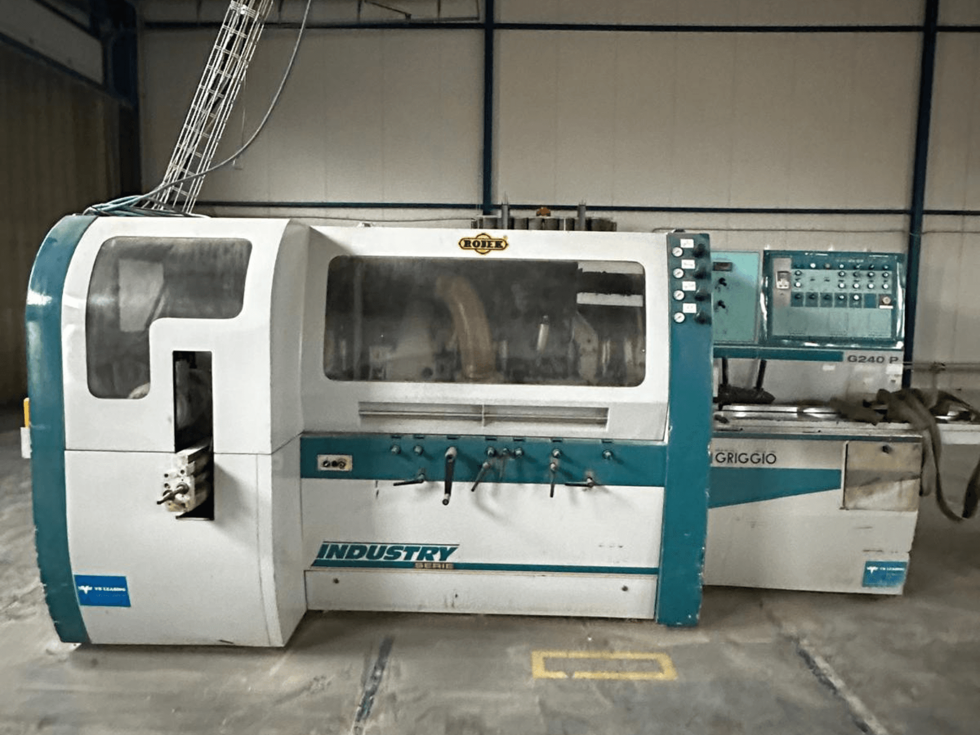 Griggio Industry G240 P mašīna, skats no priekšpuses, ar vadības paneli un caurspīdīgu korpusu, kurā redzami iekšējie mehānismi.