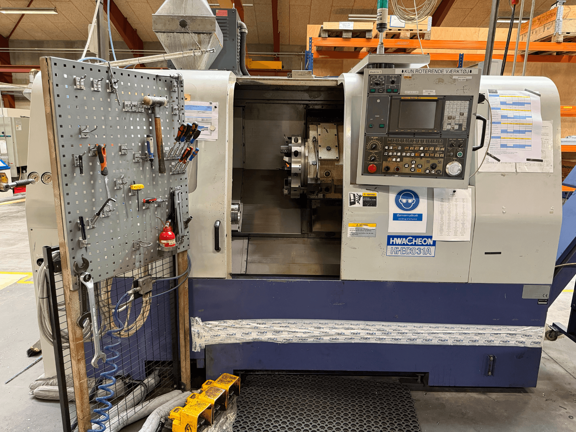 HWACHEON HiEco-31A horizontālā virpošanas mašīna ar vadības pulti, instrumentiem sānos un labu pārredzamību uz mašīnas iekšpusi.