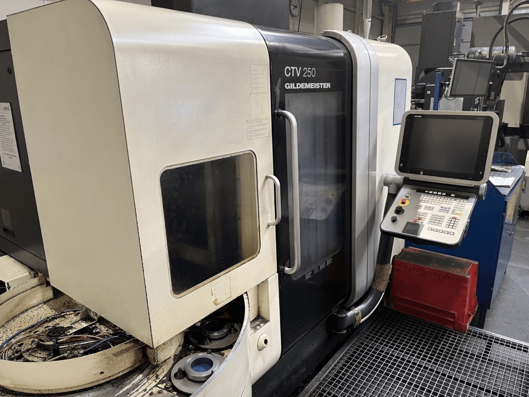 Vertikālās virpošanas darbagalds DMG CTV-250 no priekšpuses, redzams vadības panelis un darba zona ar instrumentiem.