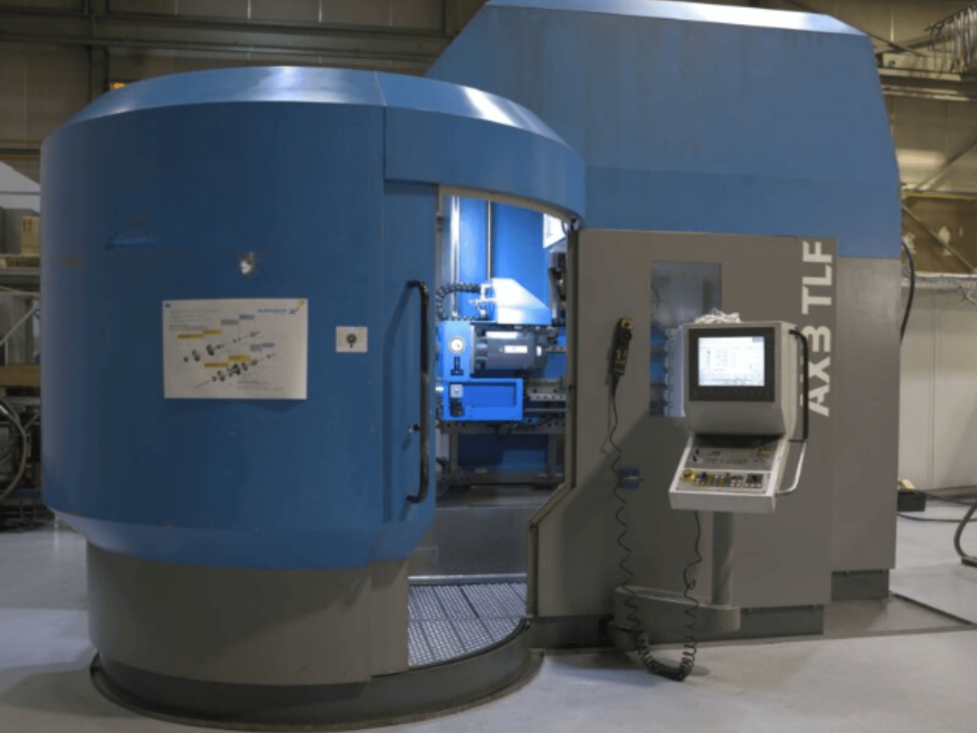 Urbjmašīna IXION Auerbach IA2 TLF-1200.4 priekšpusē; vadības panelis un zils apvalks.